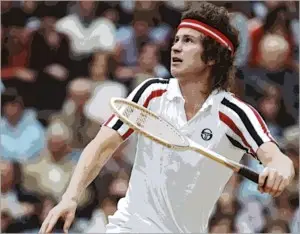 John McEnroe preparing to smash an overhead